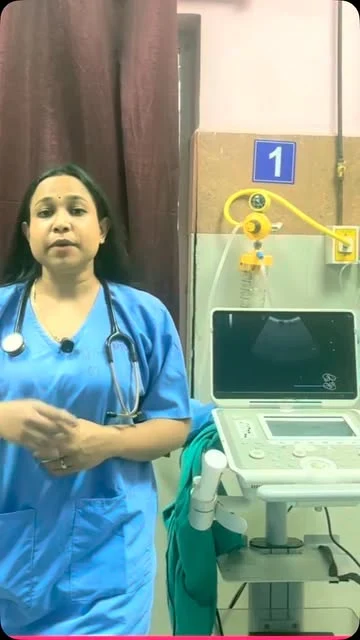 Dr. Eva beside an ultrasound machine